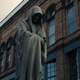 A hooded statue is borne through Castle Rock.